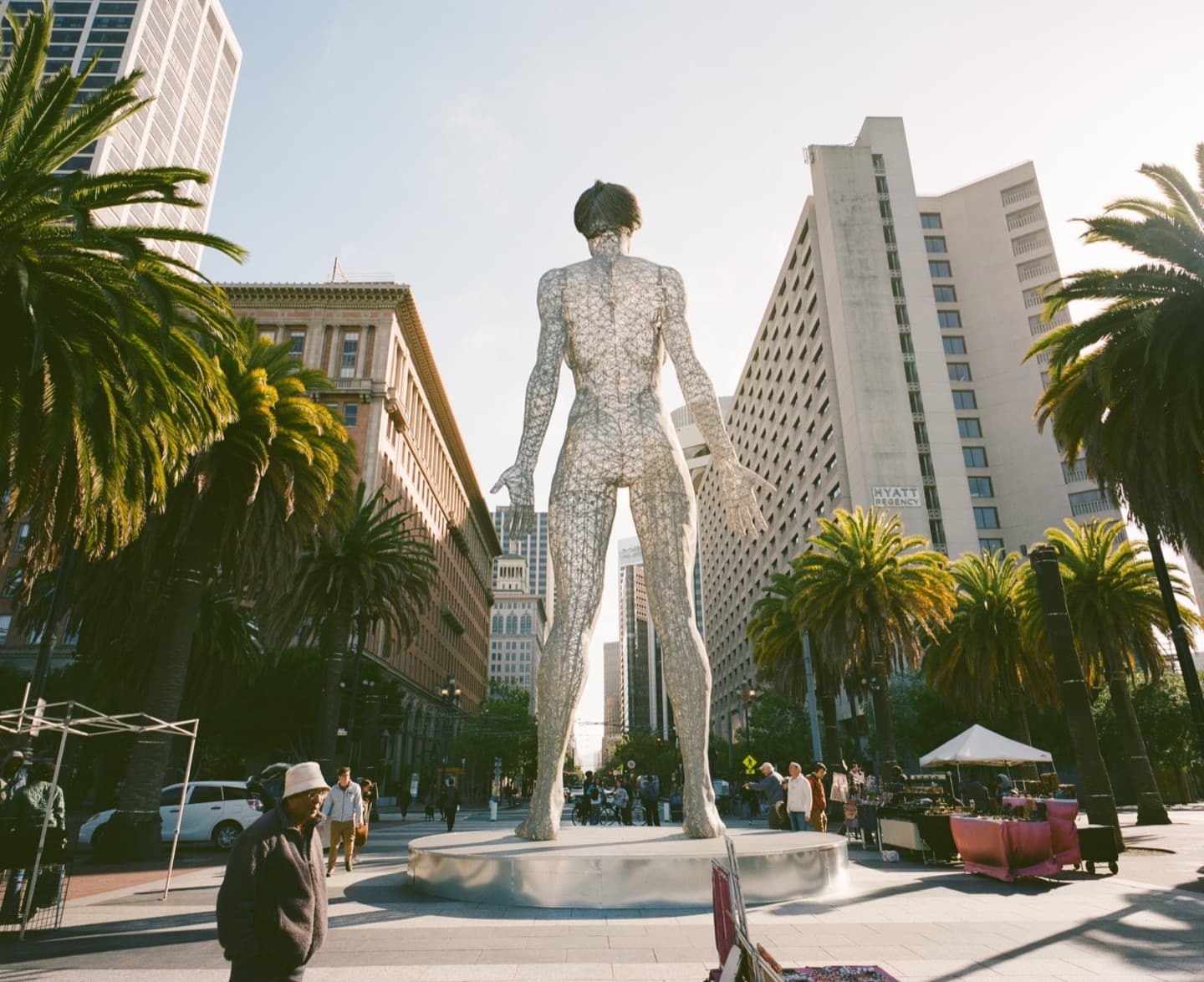 Film photograph — wire mesh human figure, architecture made visible